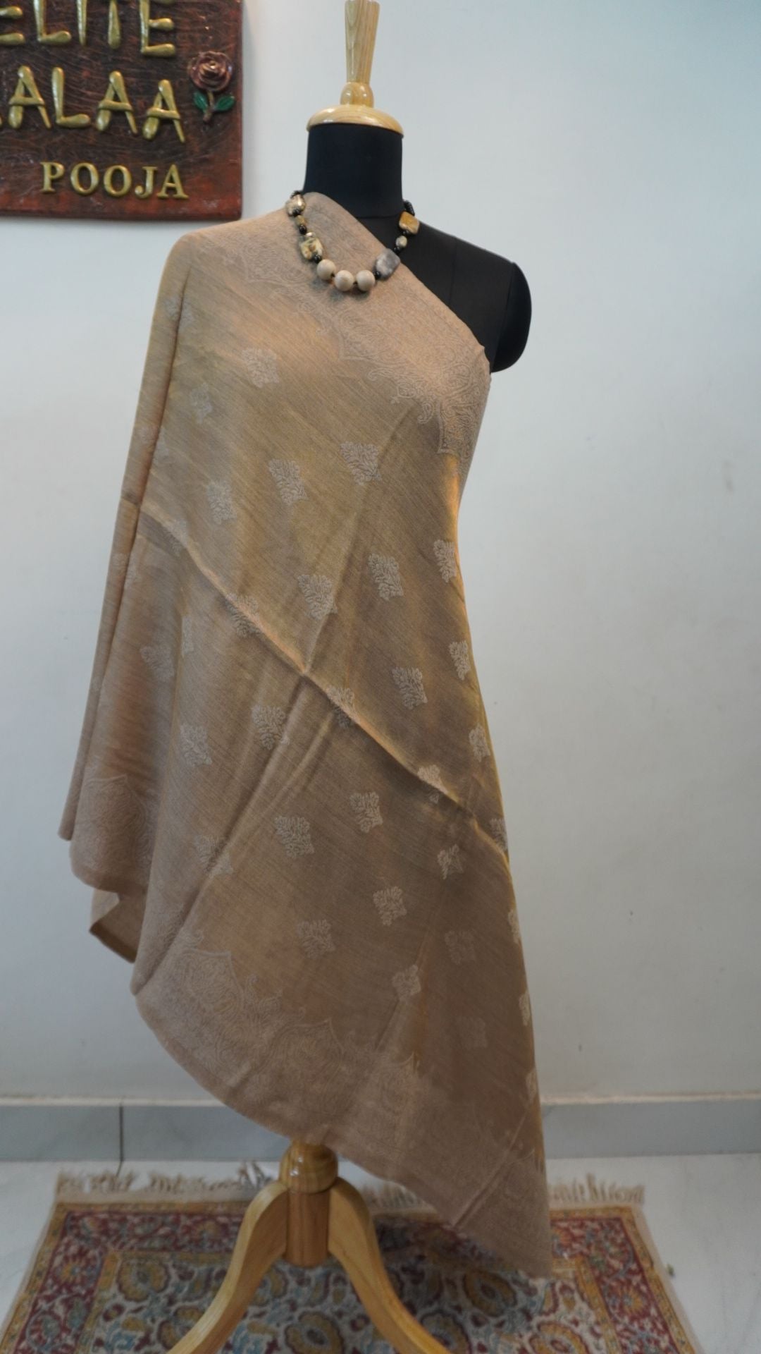 Beige fine wool stole with self zari leaf design and border detail