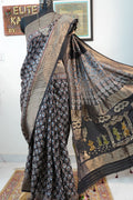 Black Dola silk Ajrakh saree with all-over pattern, border, tassels and multicolor accents