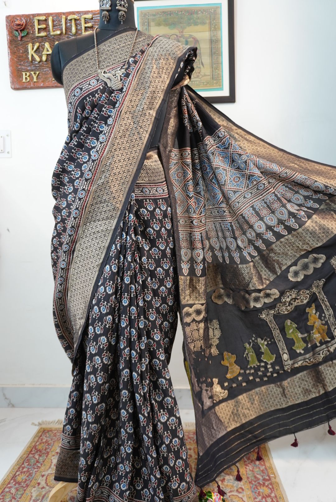Black Dola silk Ajrakh saree with all-over pattern, border, tassels and multicolor accents