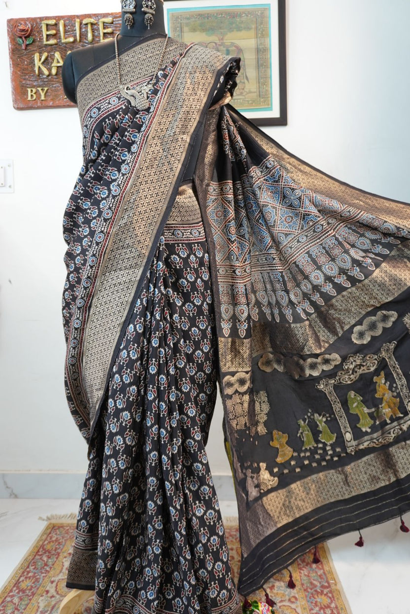 Black Dola silk Ajrakh saree with all-over pattern, border, tassels and multicolor accents
