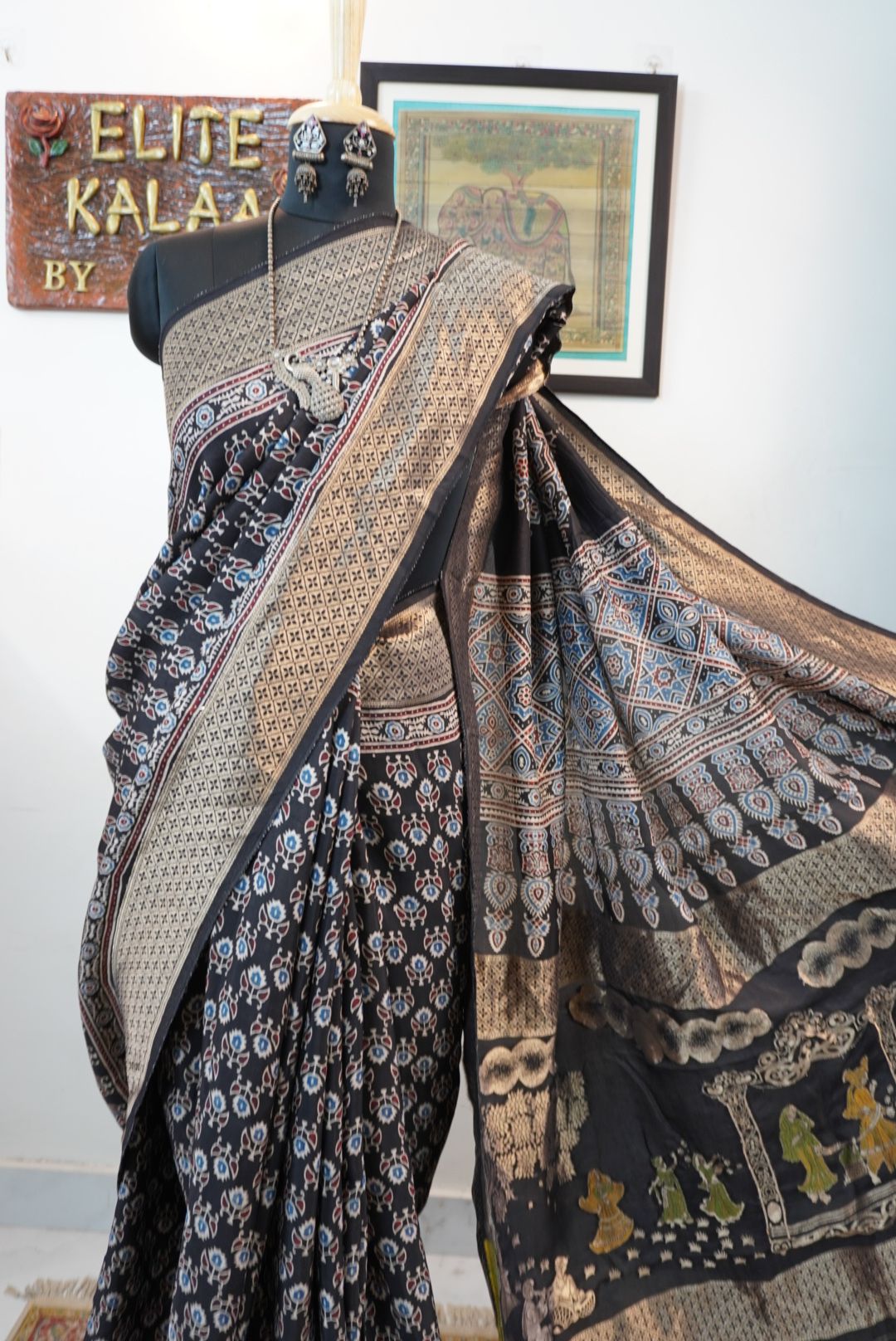 Black Dola silk Ajrakh saree with all-over pattern, border, tassels and multicolor accents