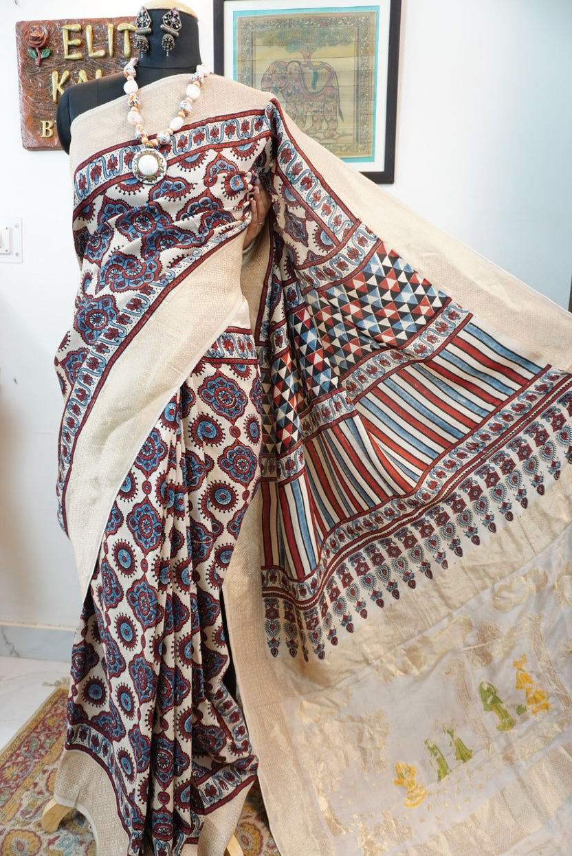 Cream Dola silk saree with Ajrakh block print, multicolor detailing and border