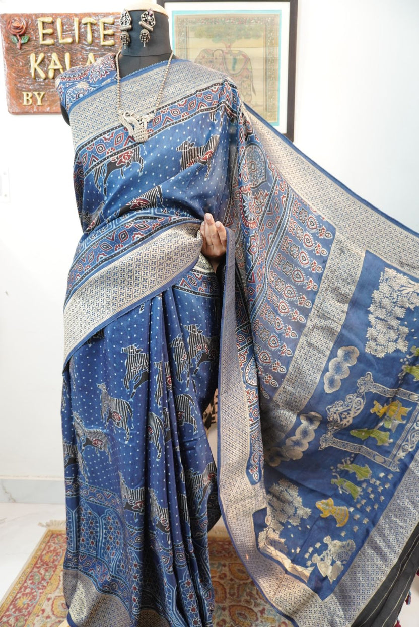 Blue saree with cream, red and black placement pattern, border and pichwai nandi block design