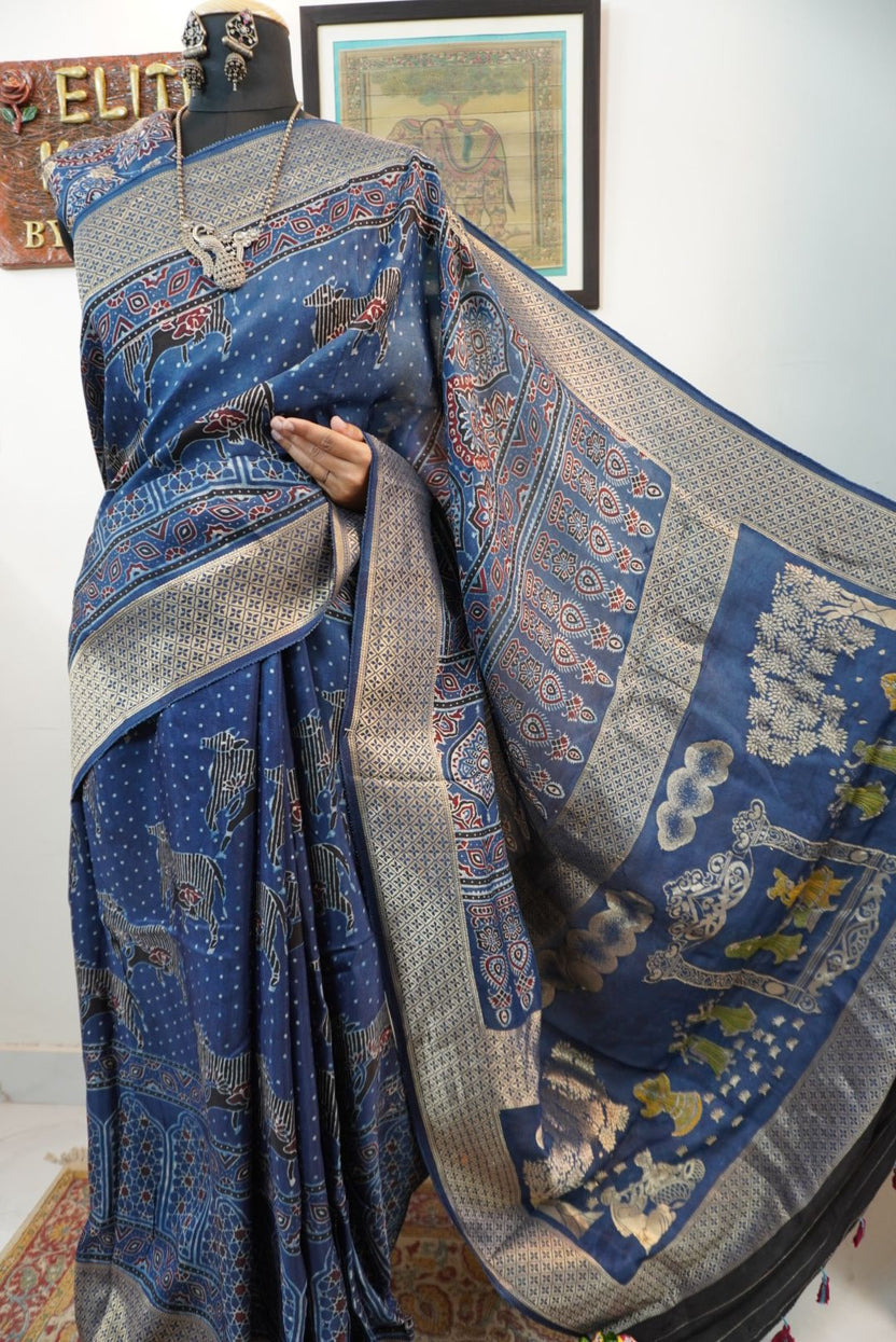 Blue saree with cream, red and black placement pattern, border and pichwai nandi block design