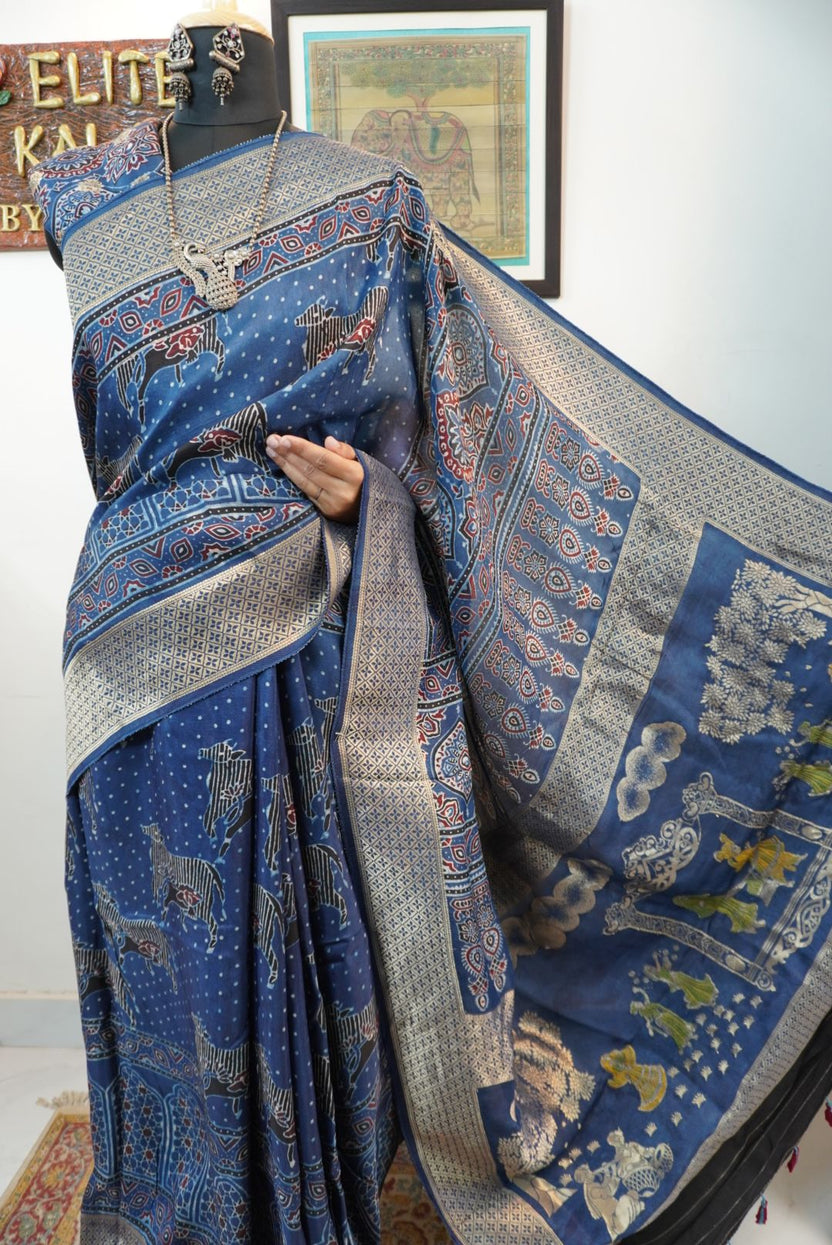 Blue saree with cream, red and black placement pattern, border and pichwai nandi block design