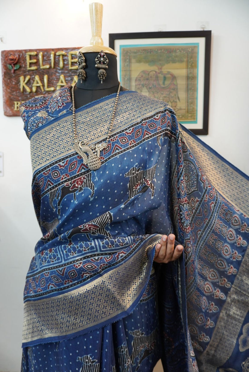 Blue saree with cream, red and black placement pattern, border and pichwai nandi block design