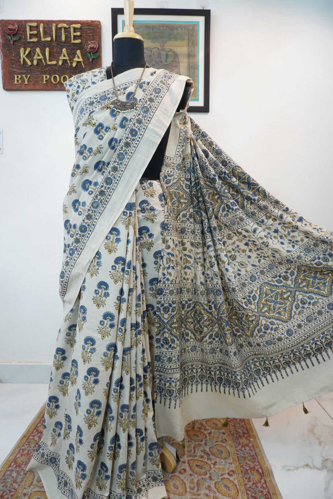 Ajrakh cotton saree in ivory with olive green and blue placement pattern, border and tassels