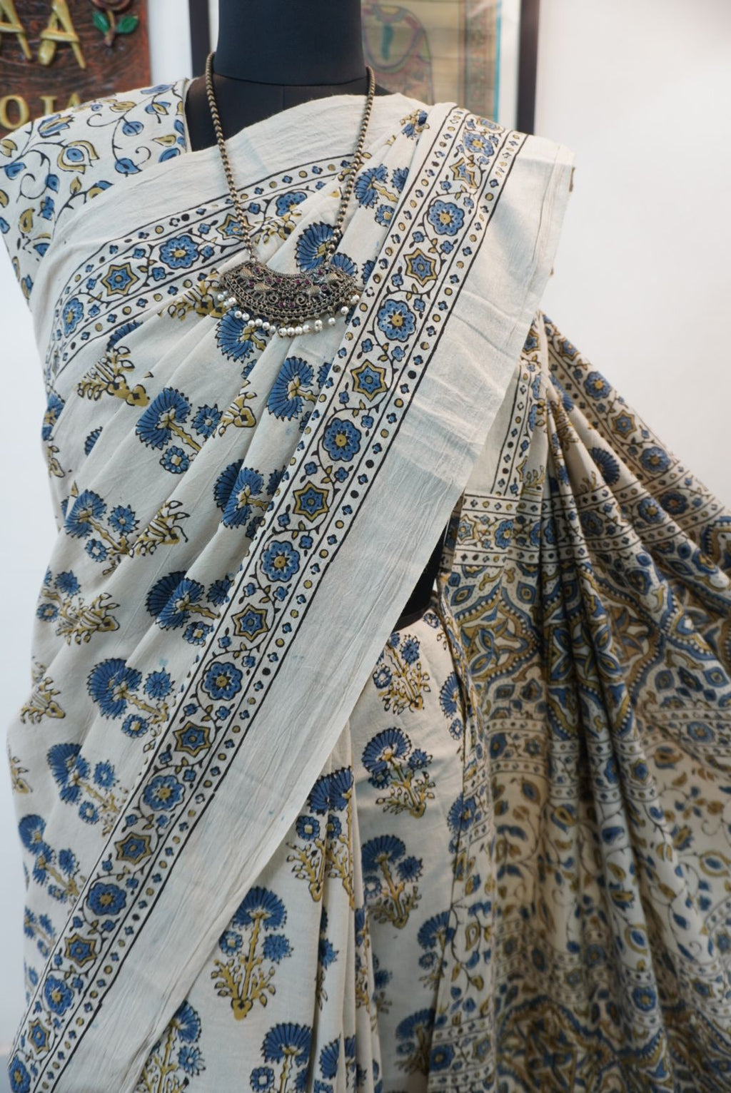 Ajrakh cotton saree in ivory with olive green and blue placement pattern, border and tassels