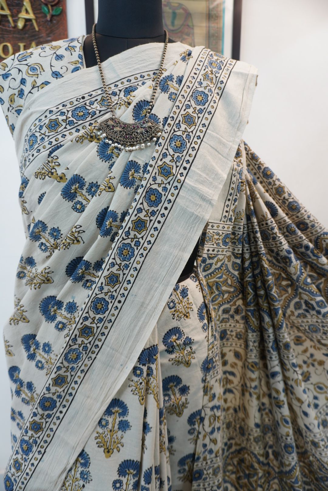 Ajrakh cotton saree in ivory with olive green and blue placement pattern, border and tassels