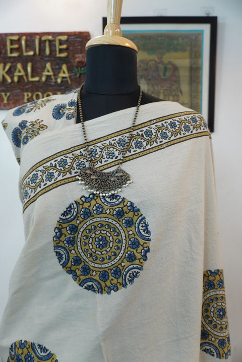 Ivory cotton Ajrakh saree with olive green, blue and yellow block print, border and tassels