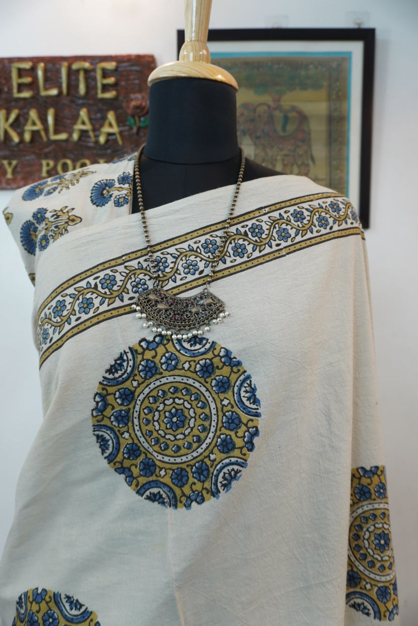 Ivory cotton Ajrakh saree with olive green, blue and yellow block print, border and tassels