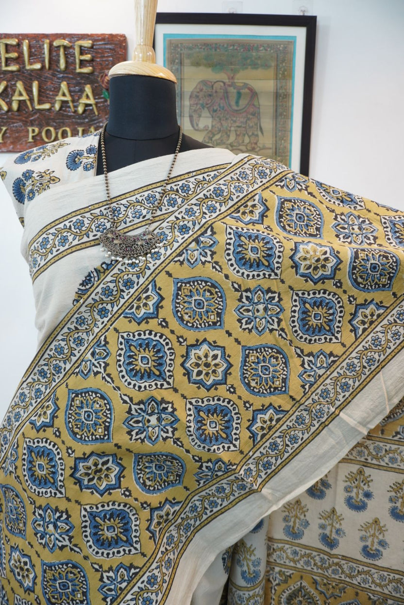 Ivory cotton Ajrakh saree with olive green, blue and yellow block print, border and tassels
