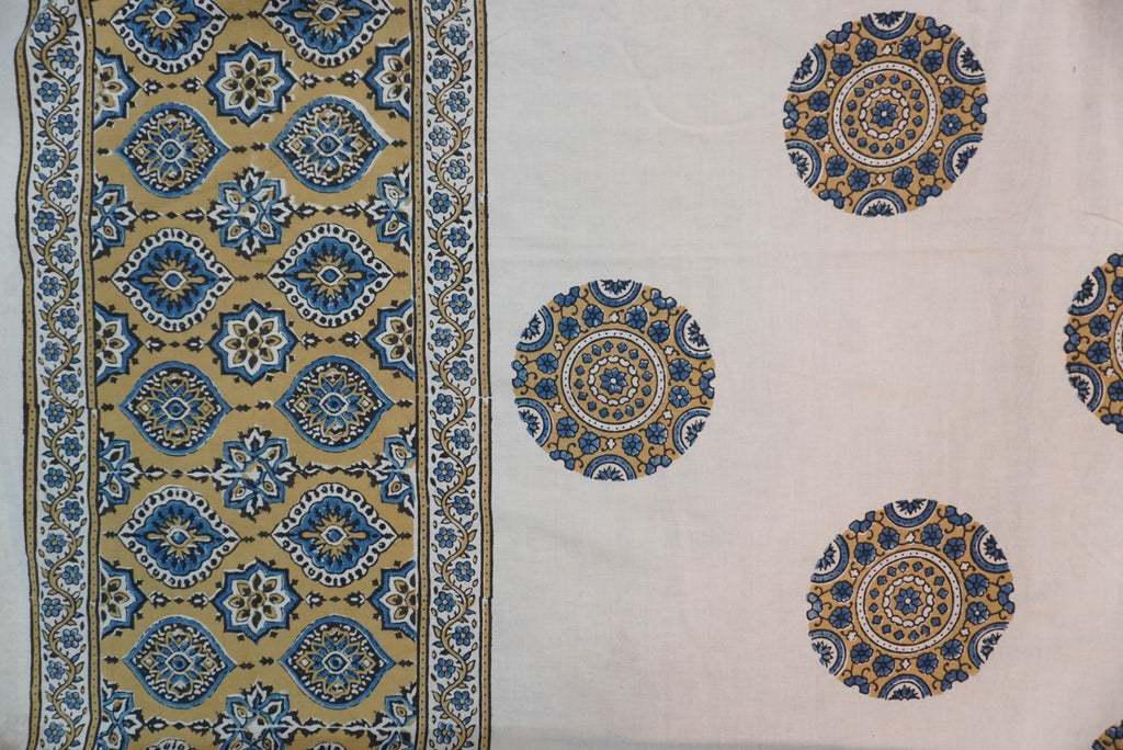 Ivory cotton Ajrakh saree with olive green, blue and yellow block print, border and tassels