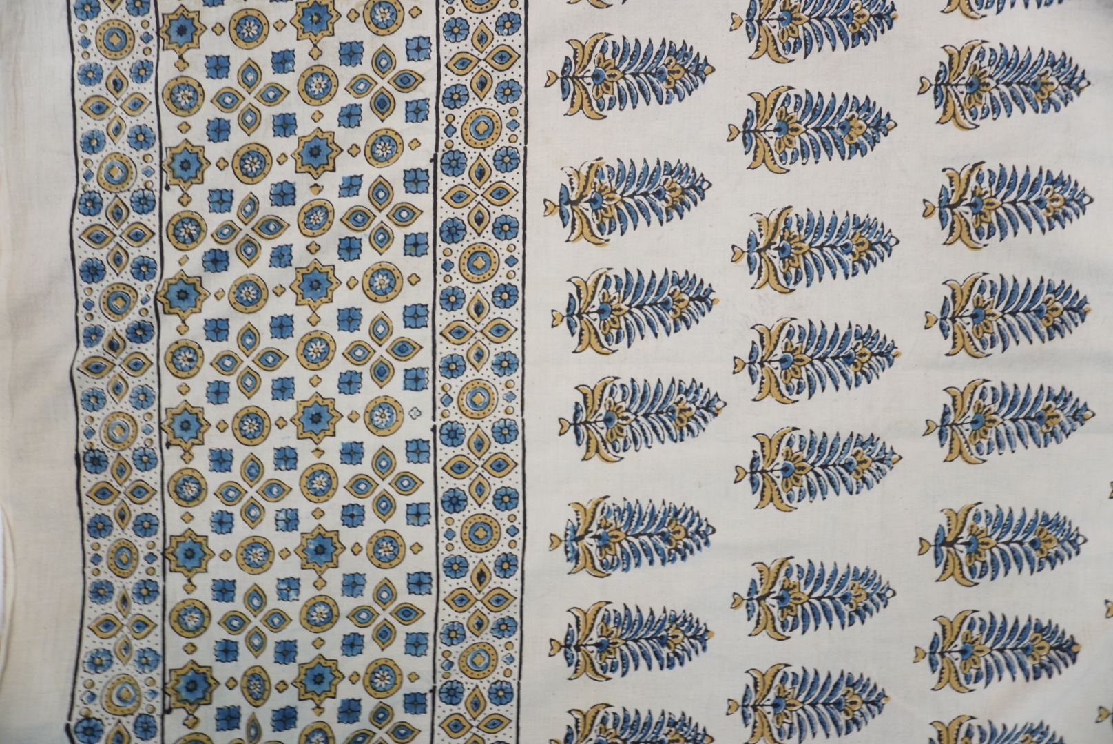 Ivory Ajrakh cotton saree with olive green and blue design, border and tassels