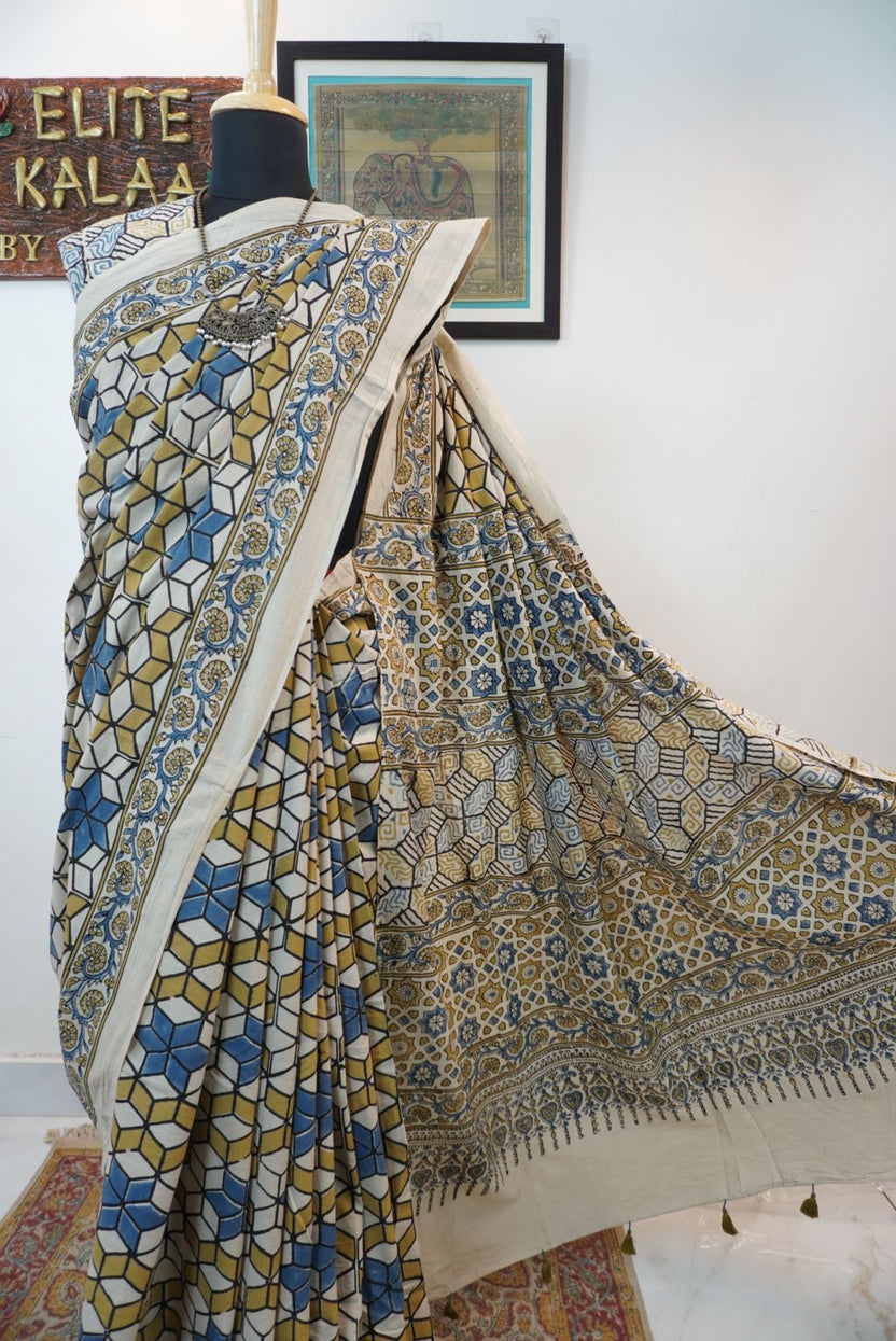 Ajrakh cotton saree in ivory with olive green, blue and yellow all-over design and border detail