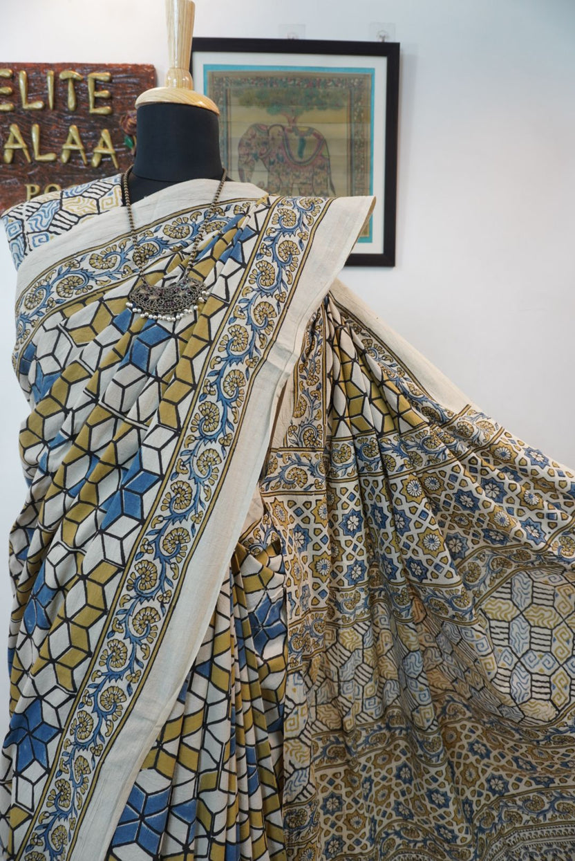 Ajrakh cotton saree in ivory with olive green, blue and yellow all-over design and border detail