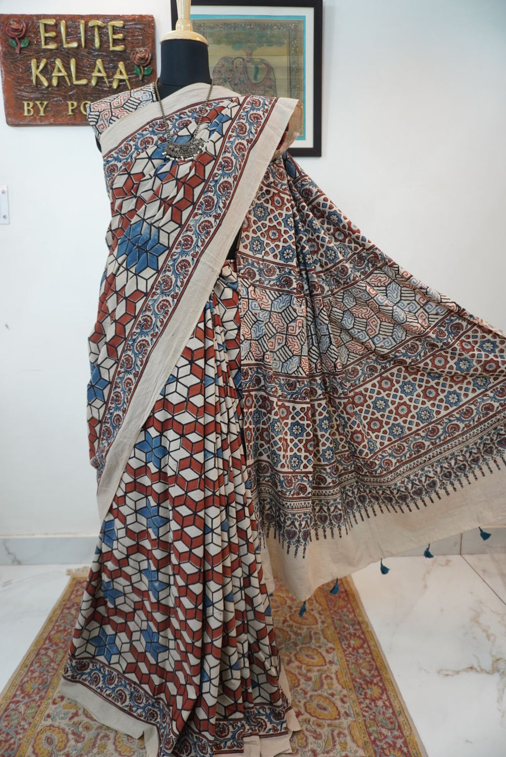 Ajrakh cotton saree in ivory with red rust and blue, all-over pattern with border and tassels