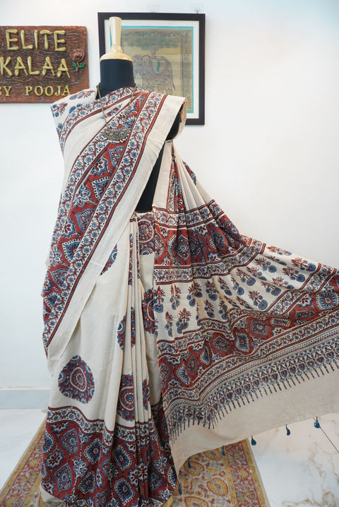 Ivory Ajrakh cotton saree with red rust and blue placement pattern, border and tassels