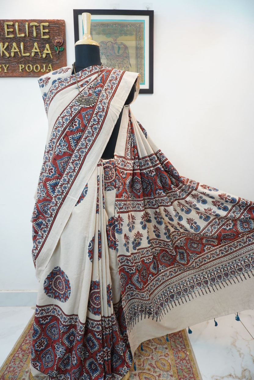 Ivory Ajrakh cotton saree with red rust and blue placement pattern, border and tassels