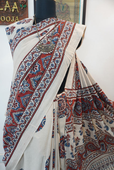 Ivory Ajrakh cotton saree with red rust and blue placement pattern, border and tassels