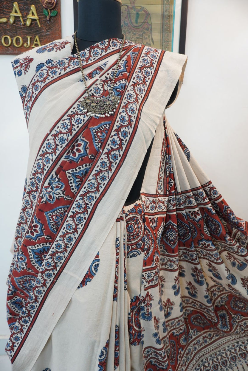 Ivory Ajrakh cotton saree with red rust and blue placement pattern, border and tassels