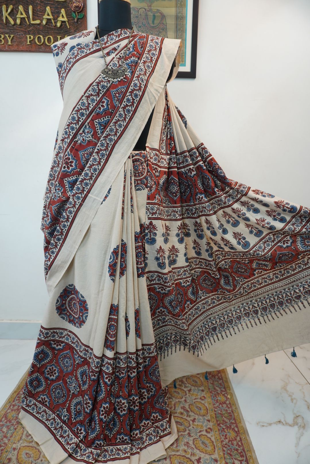 Ivory Ajrakh cotton saree with red rust and blue placement pattern, border and tassels
