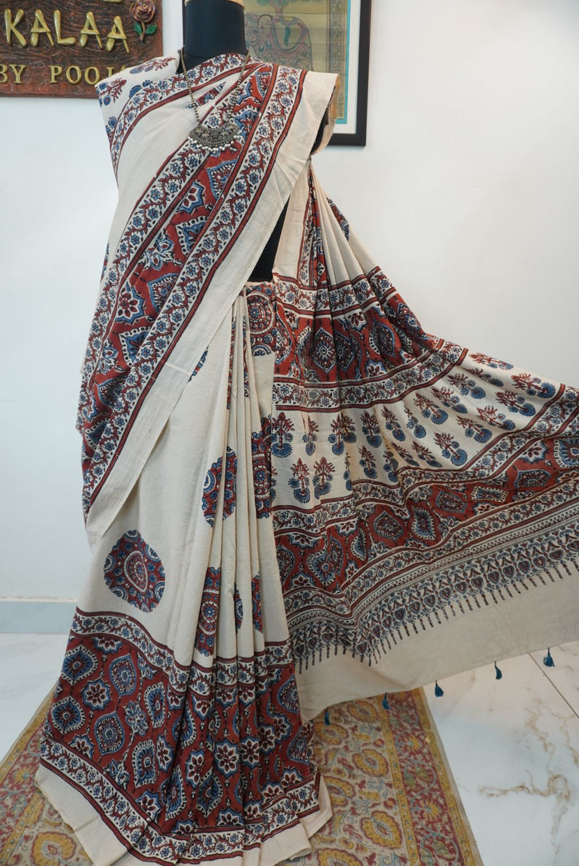Ivory Ajrakh cotton saree with red rust and blue placement pattern, border and tassels