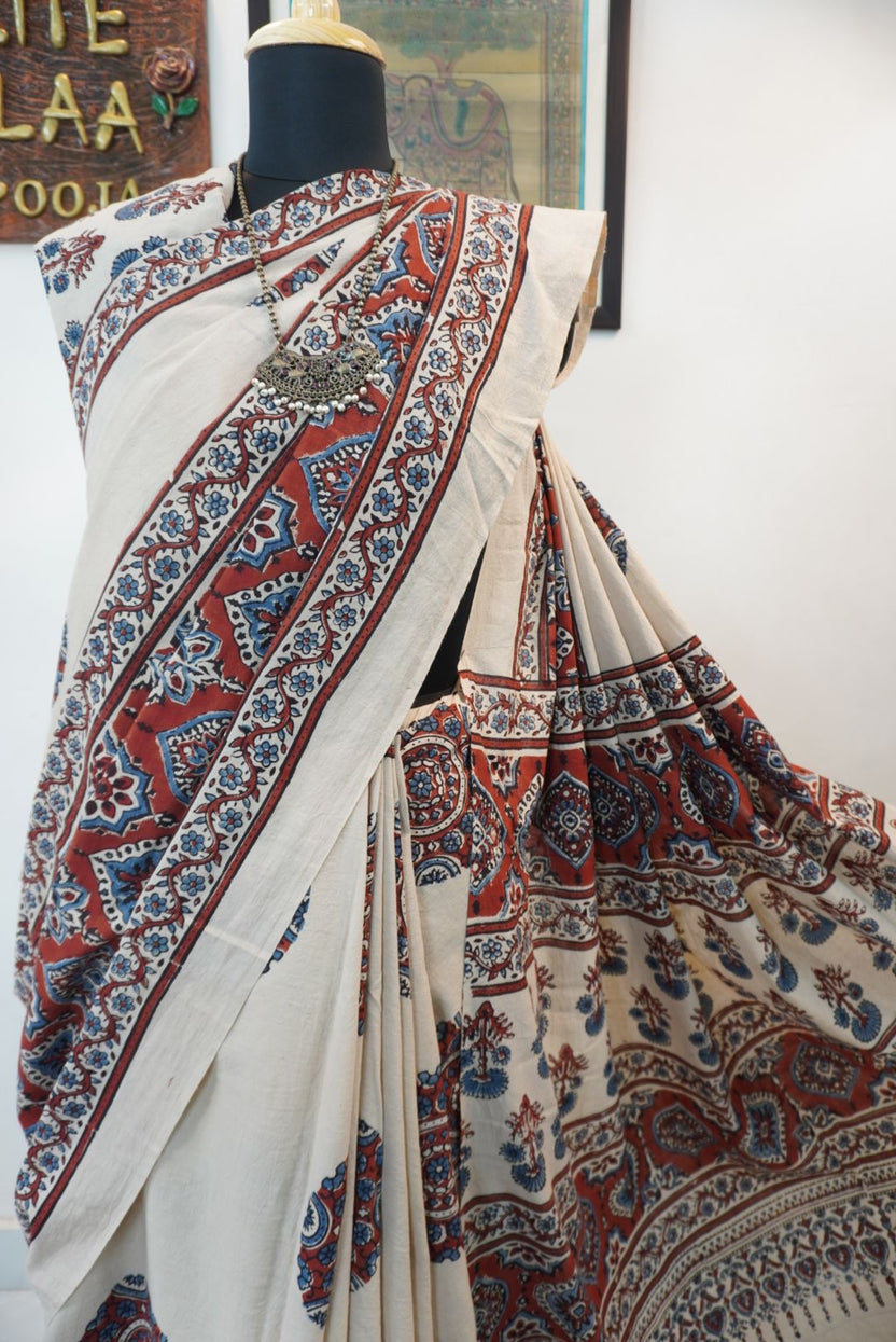 Ivory Ajrakh cotton saree with red rust and blue placement pattern, border and tassels