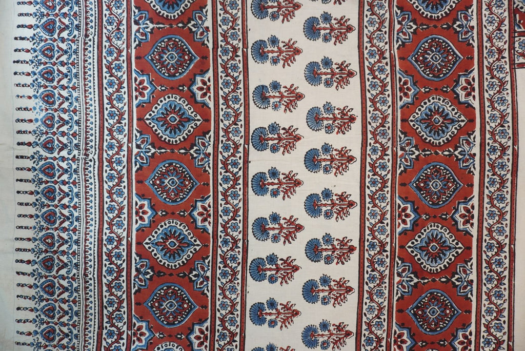 Ivory Ajrakh cotton saree with red rust and blue placement pattern, border and tassels