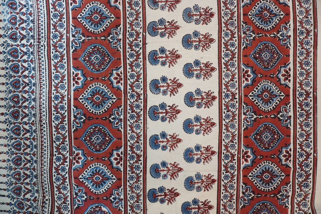 Ivory Ajrakh cotton saree with red rust and blue placement pattern, border and tassels