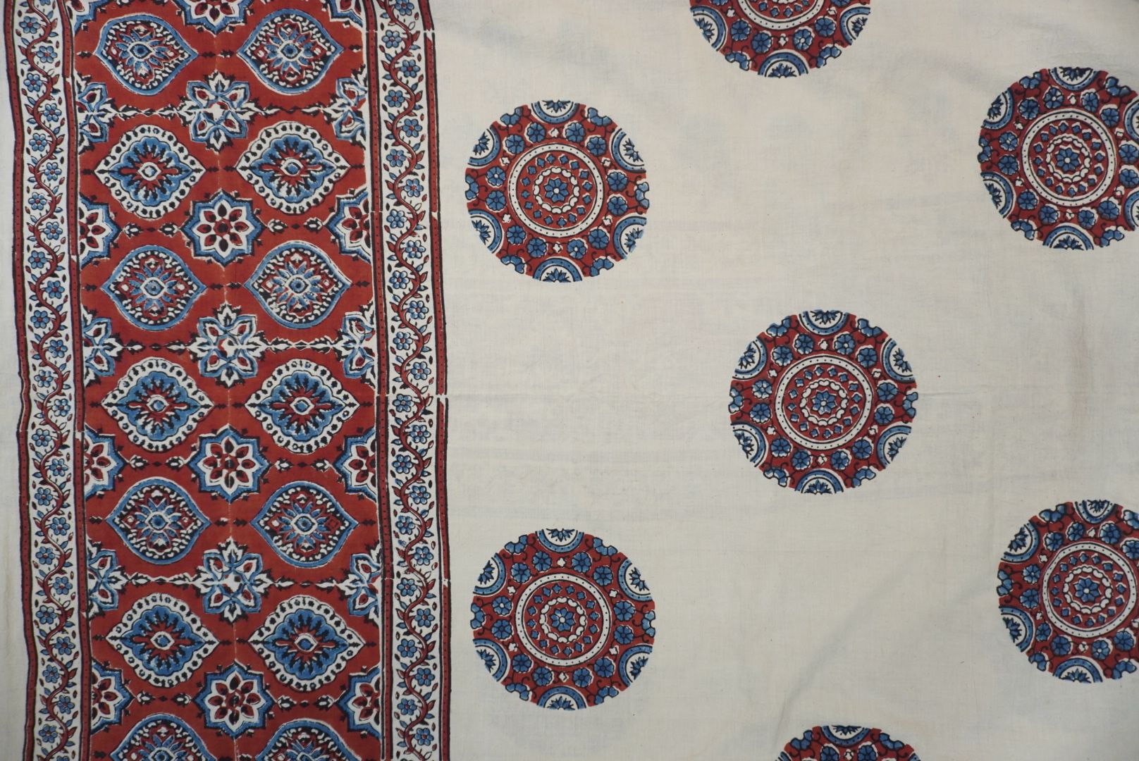Ivory Ajrakh cotton saree with red rust and blue placement pattern, border and tassels