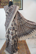 Cotton Ajrakh saree in ivory with red rust and blue, all-over pattern, border and tassels