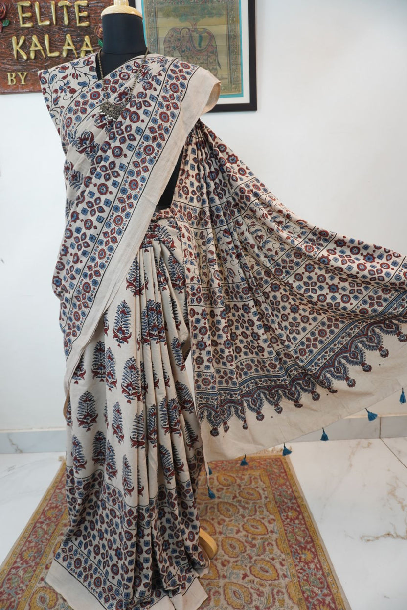 Cotton Ajrakh saree in ivory with red rust and blue, all-over pattern, border and tassels