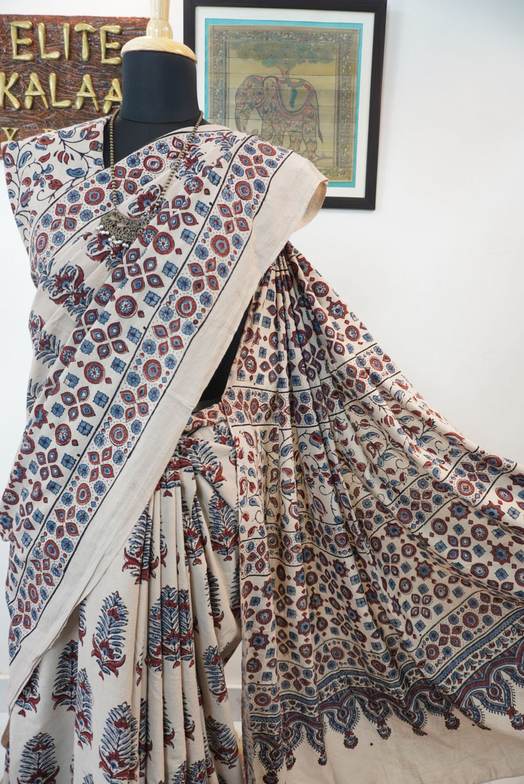 Cotton Ajrakh saree in ivory with red rust and blue, all-over pattern, border and tassels