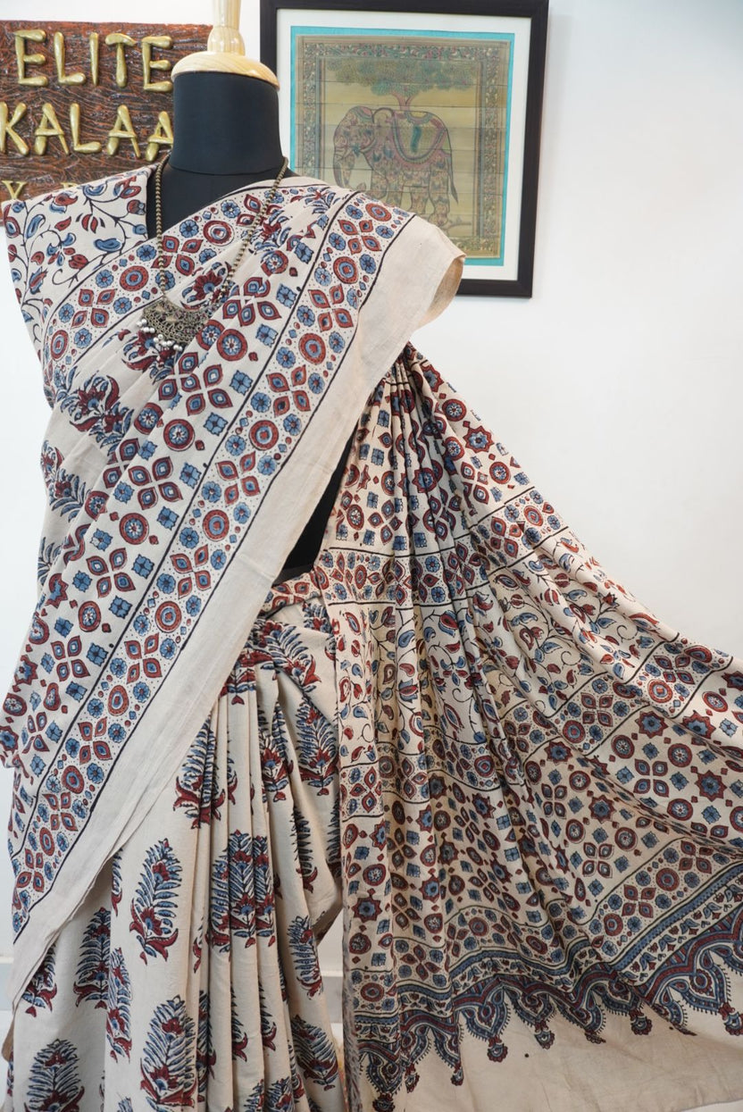 Cotton Ajrakh saree in ivory with red rust and blue, all-over pattern, border and tassels