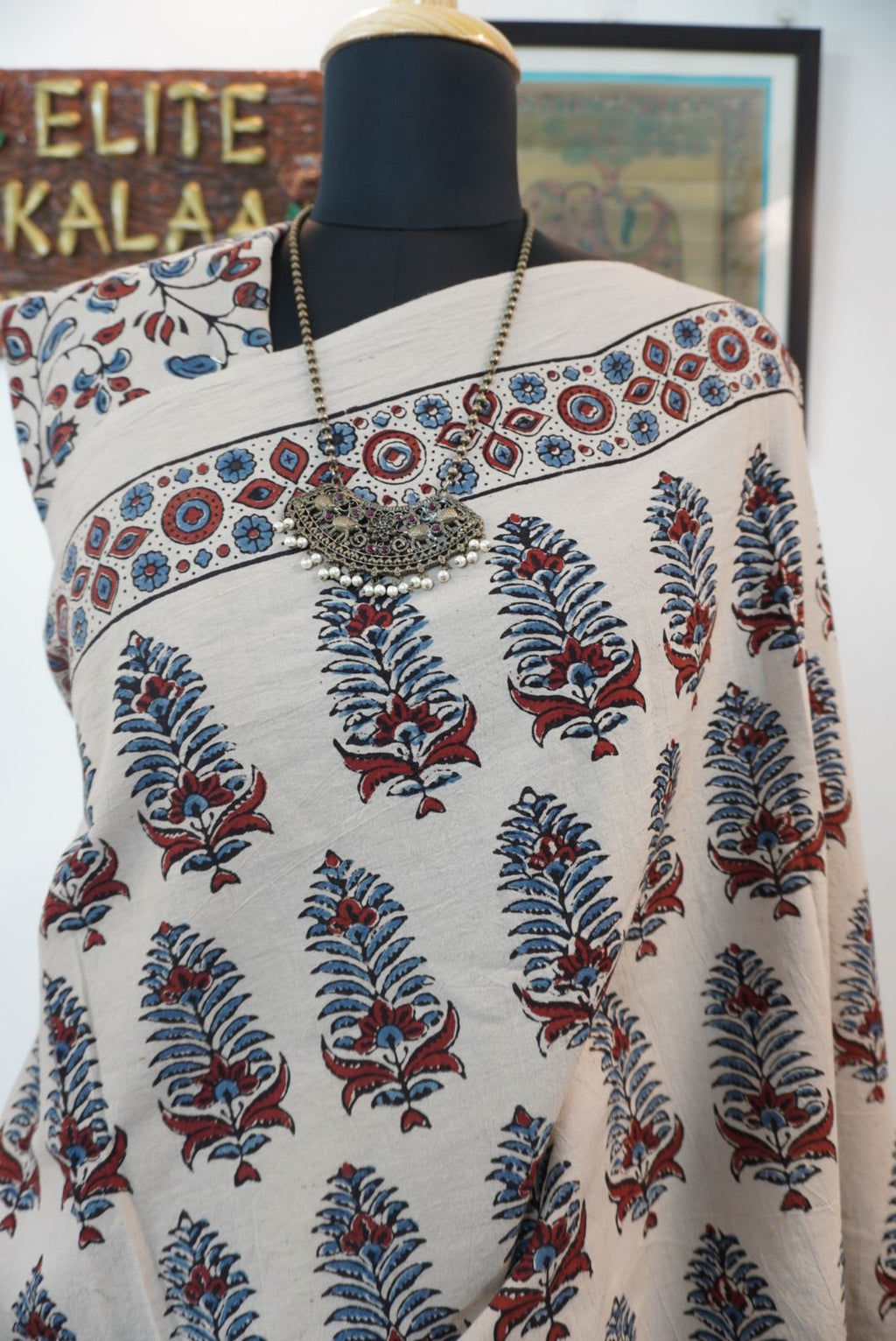 Cotton Ajrakh saree in ivory with red rust and blue, all-over pattern, border and tassels