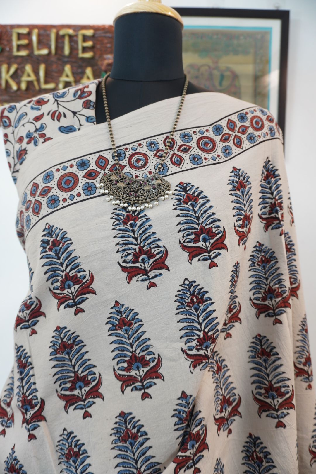 Cotton Ajrakh saree in ivory with red rust and blue, all-over pattern, border and tassels