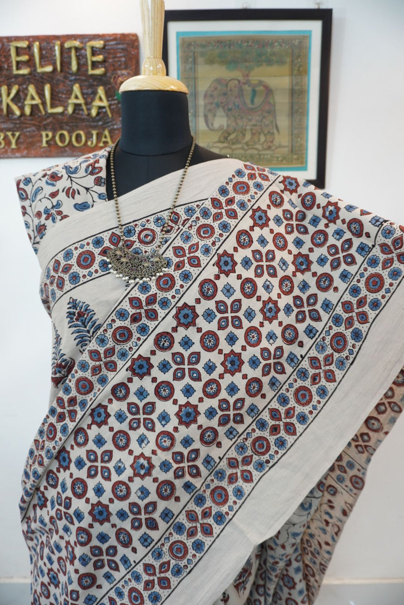 Cotton Ajrakh saree in ivory with red rust and blue, all-over pattern, border and tassels