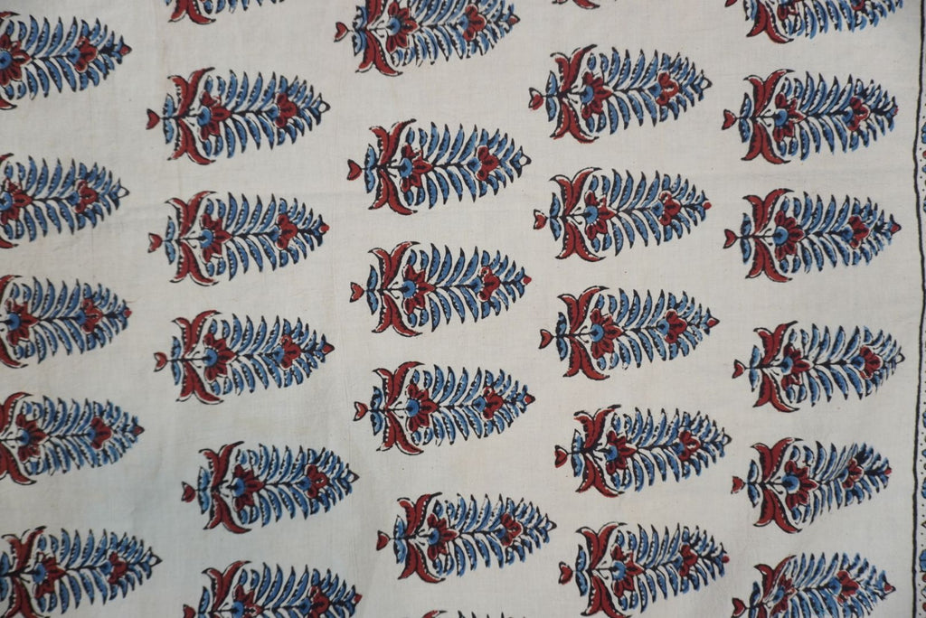 Cotton Ajrakh saree in ivory with red rust and blue, all-over pattern, border and tassels