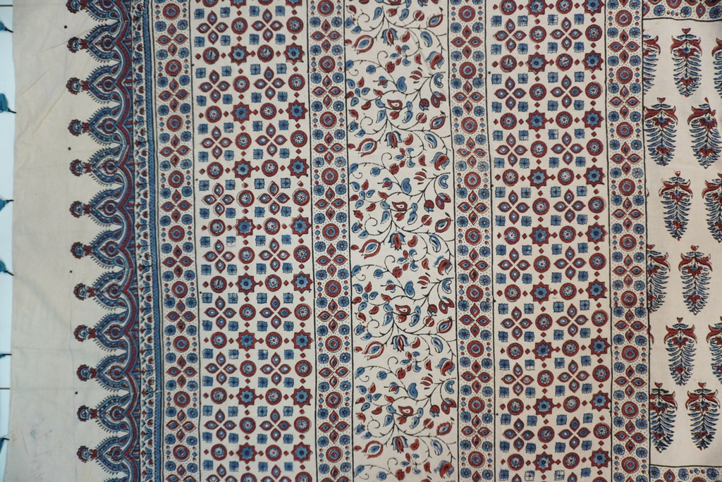 Cotton Ajrakh saree in ivory with red rust and blue, all-over pattern, border and tassels