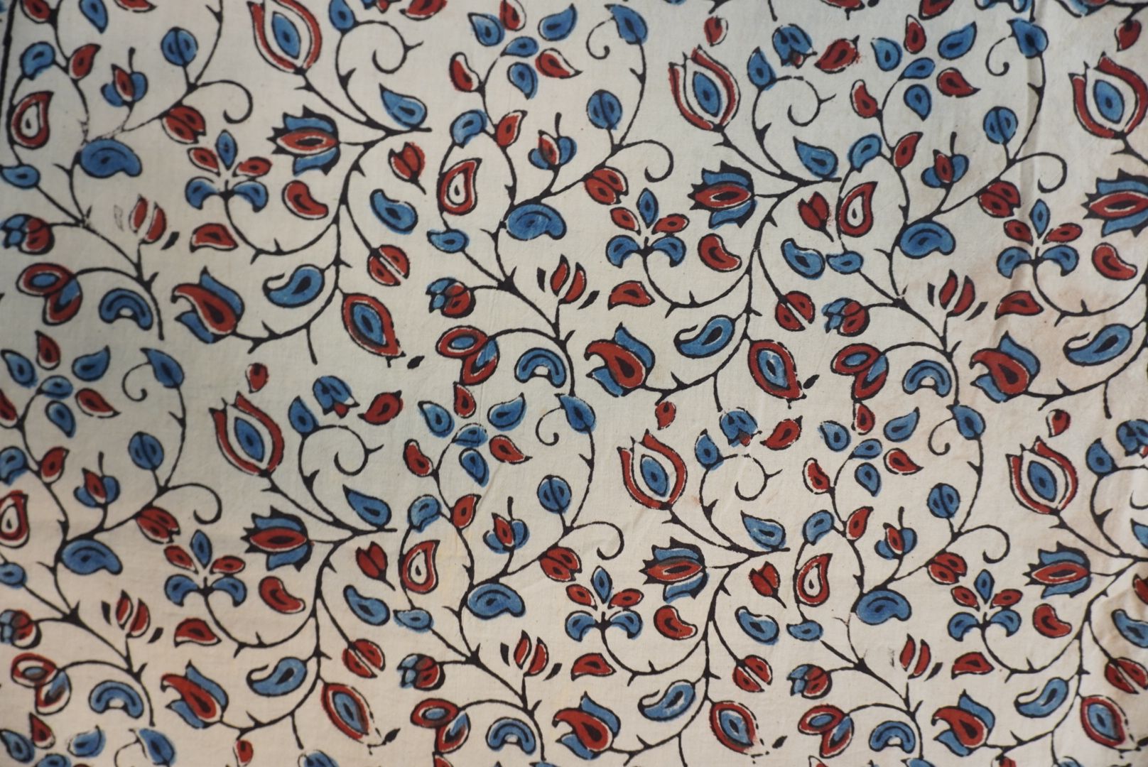 Cotton Ajrakh saree in ivory with red rust and blue, all-over pattern, border and tassels