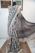 Ivory cotton Ajrakh saree with red, blue and rust placement pattern, border and tassels
