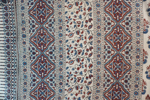 Ivory cotton Ajrakh saree with red, blue and rust placement pattern, border and tassels