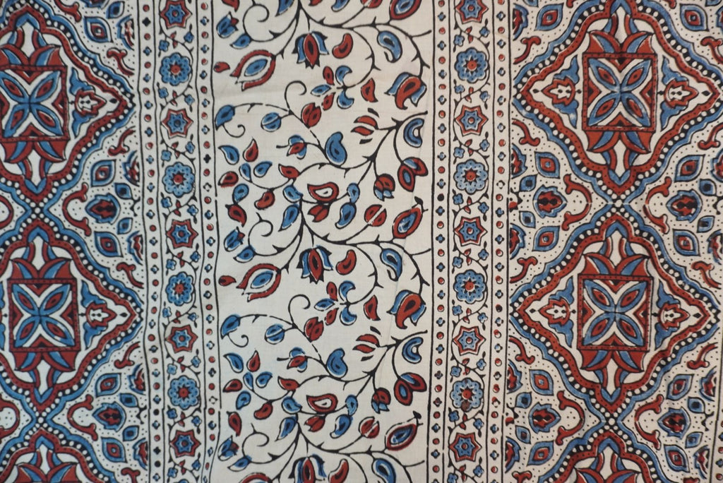 Ivory cotton Ajrakh saree with red, blue and rust placement pattern, border and tassels