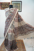 Ajrakh cotton saree in ivory with red rust and blue all-over pattern, border and tassels