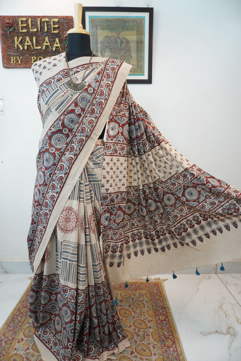 Ajrakh cotton saree in ivory with red rust and blue all-over pattern, border and tassels