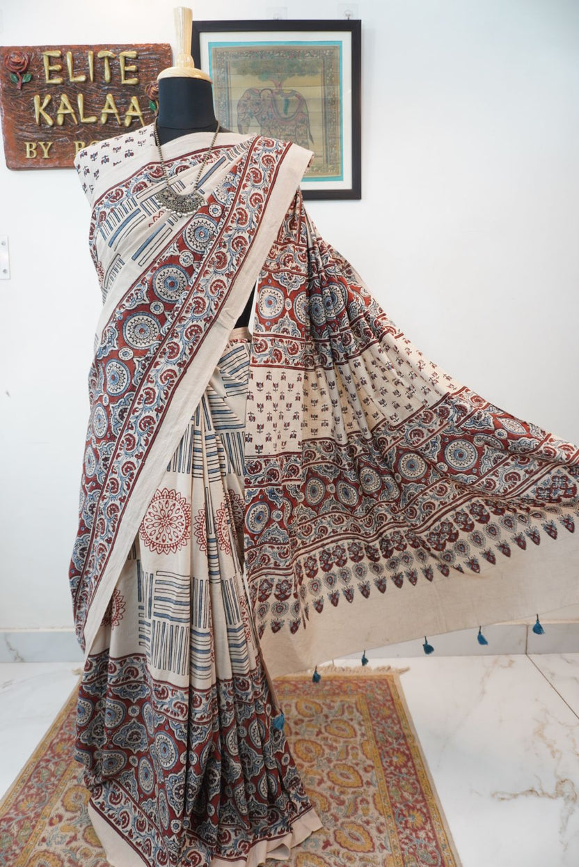 Ajrakh cotton saree in ivory with red rust and blue all-over pattern, border and tassels