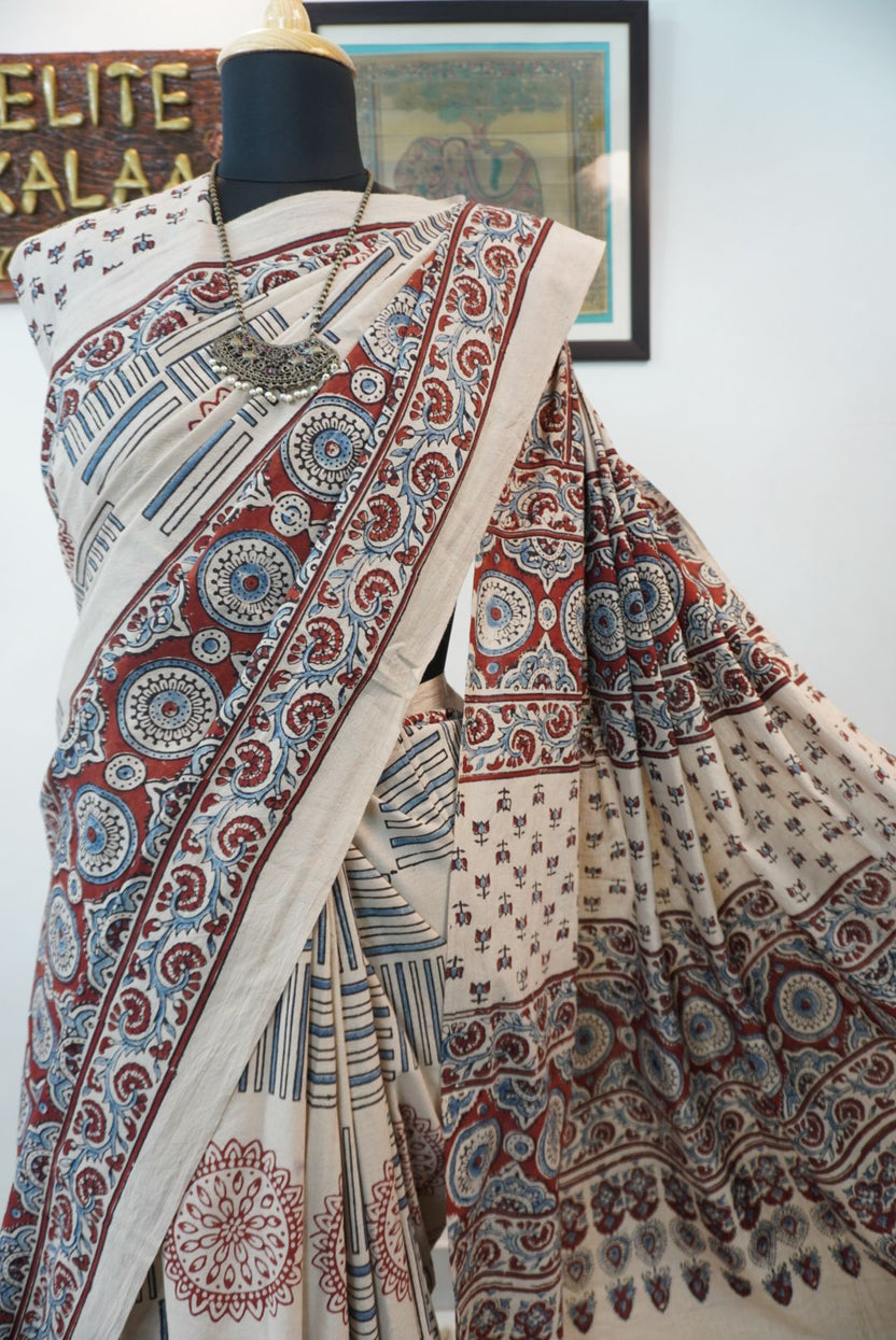 Ajrakh cotton saree in ivory with red rust and blue all-over pattern, border and tassels