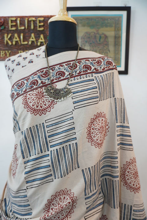 Ajrakh cotton saree in ivory with red rust and blue all-over pattern, border and tassels