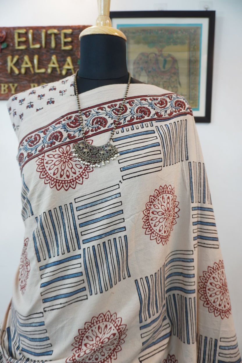 Ajrakh cotton saree in ivory with red rust and blue all-over pattern, border and tassels